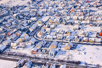 Raiffeisenstraße in winter with snow in Rheinzabern in the state Rhineland-Palatinate, Germany