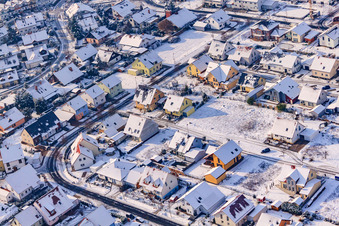 Aerial view of Raiffeisenstraße in winter with snow in Rheinzabern in the state Rhineland-Palatinate, Germany