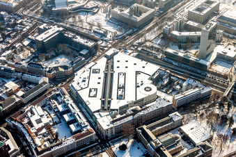 Wintry snowy Building of the shopping center Ettlinger Tor Zentrum in Karlsruhe in the state Baden-Wurttemberg, Germany