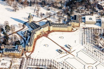 Wintry snowy Building complex in the park of the castle Schloss Karlsruhe in Karlsruhe in the state Baden-Wurttemberg, Germany from above