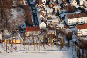Swan pond frozen in winter in Kandel in the state Rhineland-Palatinate, Germany from the plane