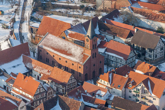 Aerial view of Wintry snowy Evangelic Church building in the village of in Steinweiler in the state Rhineland-Palatinate, Germany