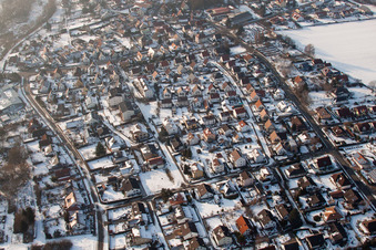 Wintry snowy Town View of the streets and houses of the residential areas in the district Ingenheim in Billigheim-Ingenheim in the state Rhineland-Palatinate