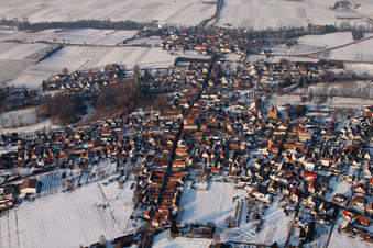Wintry snowy Town View of the streets and houses of the residential areas in the district Ingenheim in Billigheim-Ingenheim in the state Rhineland-Palatinate from above