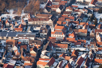 Church in the town center in winter with snow in the district Ingenheim in Billigheim-Ingenheim in the state Rhineland-Palatinate, Germany