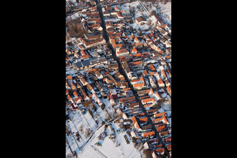 Wintry snowy Town View of the streets and houses of the residential areas in the district Ingenheim in Billigheim-Ingenheim in the state Rhineland-Palatinate seen from above