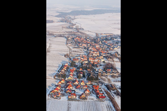 Wintry snowy Village - view on the edge of agricultural fields and farmland in Niederhorbach in the state Rhineland-Palatinate, Germany