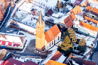 Aerial view of Wintry snowy Church building in the village of in Kapellen-Drusweiler in the state Rhineland-Palatinate, Germany