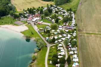 Camping with caravans and tents at the lake shore in Roeschwoog in Grand Est, France