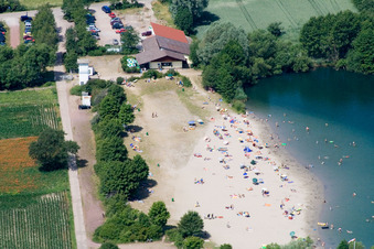 Bathers on the beach and the shore areas of the lake Johanneswiese in Jockgrim in Jockgrim in the state Rhineland-Palatinate