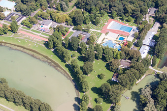 Bathers on the lawn by the pool of the swimming pool Rheinstrandbad Rappenwoert in the district Daxlanden in Karlsruhe in the state Baden-Wurttemberg, Germany