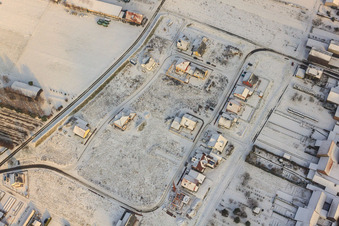 Aerial view of New development in tobacco field in winter with snow in Hatzenbühl in the state Rhineland-Palatinate, Germany