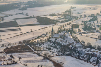 St. Dionysius in Hinterstädel in winter with snow in Jockgrim in the state Rhineland-Palatinate, Germany