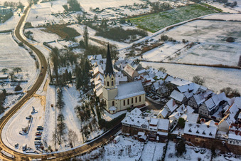 Aerial view of St. Dionysius in Hinterstädel in winter with snow in Jockgrim in the state Rhineland-Palatinate, Germany