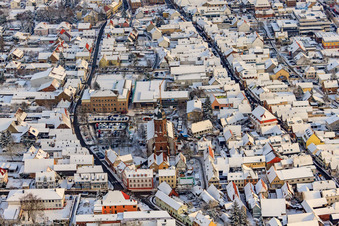 Aerial view of Christmas market at Plätzl and around St. George's Church in snow in Kandel in the state Rhineland-Palatinate, Germany