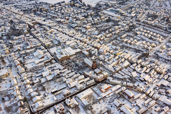 Oblique view of Christmas market at Plätzl and around St. George's Church in snow in Kandel in the state Rhineland-Palatinate, Germany