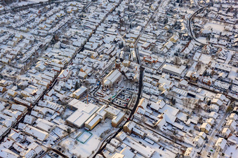 Bird's eye view of Christmas market at Plätzl and around St. George's Church in snow in Kandel in the state Rhineland-Palatinate, Germany