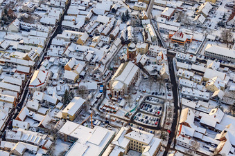Christmas market at Plätzl and around St. George's Church in snow in Kandel in the state Rhineland-Palatinate, Germany viewn from the air