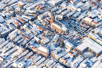 Christmas market at Plätzl and around St. George's Church in snow in Kandel in the state Rhineland-Palatinate, Germany from above