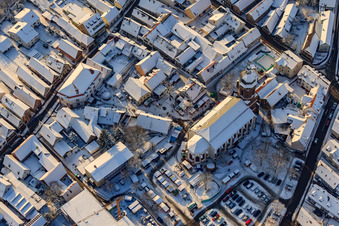 Christmas market around St. George's Church in winter with snow in Kandel in the state Rhineland-Palatinate, Germany