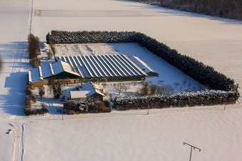 Aerial view of Sudetenhof in winter with snow in Steinweiler in the state Rhineland-Palatinate, Germany