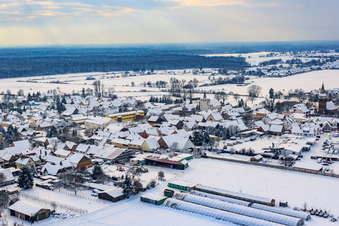 Village view in winter with snow in Minfeld in the state Rhineland-Palatinate, Germany