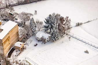 Aerial view of Hardtmühle in winter with snow in Kandel in the state Rhineland-Palatinate, Germany