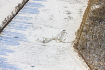 Tractor tracks on a meadow in the Otterbachtal valley in snow in winter in Kandel in the state Rhineland-Palatinate, Germany