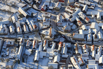Aerial view of St. Laurentius in snow in winter in the district Büchelberg in Wörth am Rhein in the state Rhineland-Palatinate, Germany