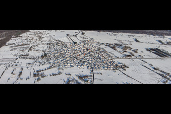 Village in forest clearing from the south in snow in winter in the district Büchelberg in Wörth am Rhein in the state Rhineland-Palatinate, Germany