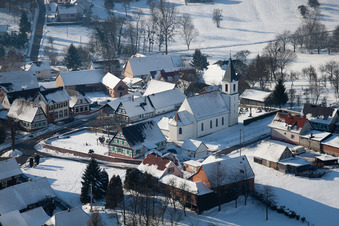 Wintry snowy Church building in the village of in Eberbach-Seltz in Grand Est, France