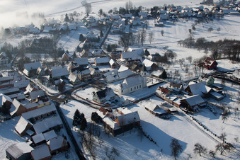 Aerial view of Wintry snowy Church building in the village of in Eberbach-Seltz in Grand Est, France