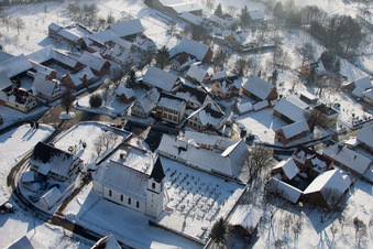 Aerial photograpy of Wintry snowy Church building in the village of in Eberbach-Seltz in Grand Est, France