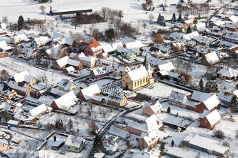 Wintry snowy Church building in the village of in Oberlauterbach in Grand Est, France