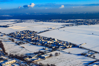 Village view from the northwest in snow in winter in the district Minderslachen in Kandel in the state Rhineland-Palatinate, Germany