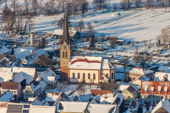 Aerial photograpy of Wintry snowy Catholic Church building in the village of in Steinweiler in the state Rhineland-Palatinate, Germany