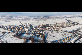 Aerial view of Panorama perspecitve of Wintry snowy Village - view on the edge of agricultural fields and farmland in Rohrbach in the state Rhineland-Palatinate, Germany