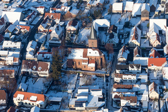 Aerial view of Wintry snowy Church building in the village of in Rohrbach in the state Rhineland-Palatinate, Germany