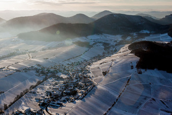 Aerial photograpy of Wintry snowy Village - view on the edge of snowed wine yards in Ranschbach in the state Rhineland-Palatinate, Germany
