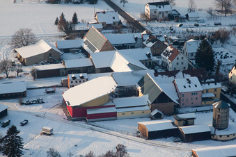 Aerial view of Wintry snowy Panel rows of photovoltaic turnable roof of a stable in the district Deutschhof in Kapellen-Drusweiler in the state Rhineland-Palatinate