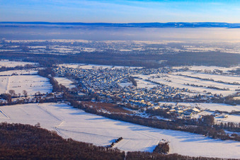 Village view in snow in winter from the west in Neuburg am Rhein in the state Rhineland-Palatinate, Germany