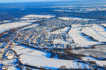 Oblique view of Village view in snow in winter from the west in Neuburg am Rhein in the state Rhineland-Palatinate, Germany