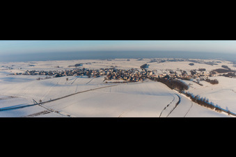 Wintry snowy Village - view on the edge of agricultural fields and farmland in Wintzenbach in Grand Est, France
