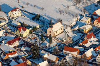 Aerial view of Wintry snowy Church building Eglise protestante de Wintzenbach in Wintzenbach in Grand Est, France