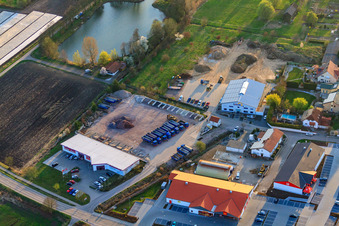 Im Riegel commercial area with Schuh-Hanss at the pond of the Herxheim Sports Fishing Association in Herxheim bei Landau in the state Rhineland-Palatinate, Germany