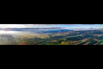 Panorama of sunrise over the landscape with paraglider pilots in Sinalunga in the state Siena, Italy