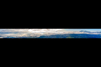 Panoramic perspective of Rocky and mountainous landscape with clouds and paraglider in Montepulciano in Toskana, Italy