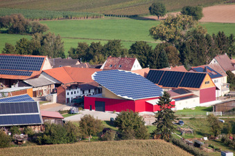 Oblique view of Panel rows of photovoltaic turnable roof of a stable in the district Deutschhof in Kapellen-Drusweiler in the state Rhineland-Palatinate