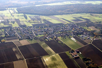 Village - view on the edge of agricultural fields and farmland in Minfeld in the state Rhineland-Palatinate from above