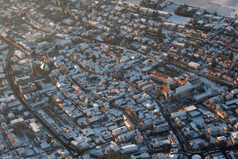 Oblique view of Wintry snowy townscape with streets and houses of the residential areas in Bad Bergzabern in the state Rhineland-Palatinate